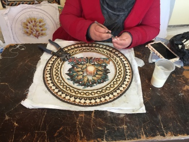 visiting a local centre where they train people to make mosaics